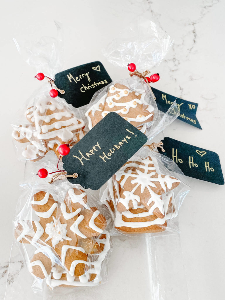 custom christmas cookies in clear gift bags with black label tags and gold writing 
