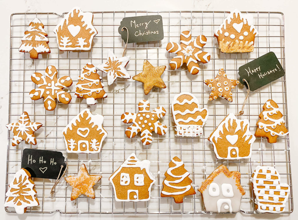 Gingerbread cookies with white icing on cookie cooling rack