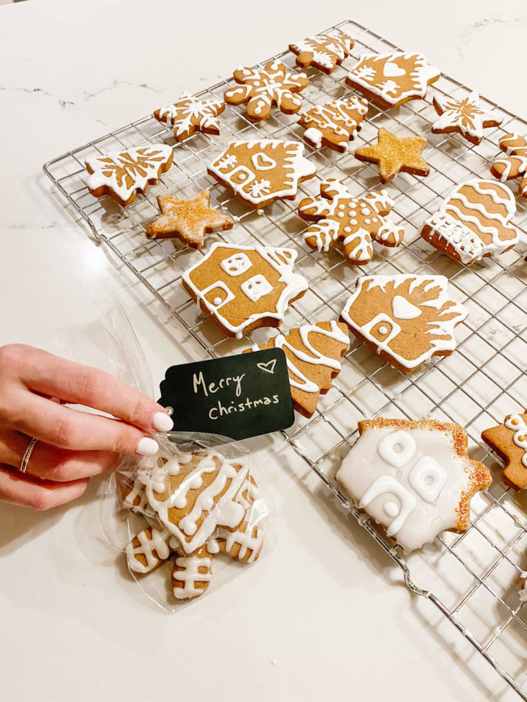 Gingerbread with white icing in clear gift bag with merry christmas label 